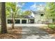 Exterior view of a home with a three-car garage, well-maintained landscaping, and ample parking space at 3060 Bohicket Rd, Johns Island, SC 29455