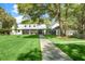 Charming home with a metal roof, a stone walkway, and a well-manicured lawn at 3060 Bohicket Rd, Johns Island, SC 29455