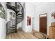 Welcoming foyer featuring a spiral staircase, white wainscoting, and hardwood floors at 3060 Bohicket Rd, Johns Island, SC 29455