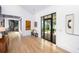 Elegant hallway with hardwood floors, black framed doors, and unique spiral staircase at 3060 Bohicket Rd, Johns Island, SC 29455