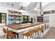 Open kitchen with a large island, wood countertops, bar stools, and modern lighting fixtures at 3060 Bohicket Rd, Johns Island, SC 29455