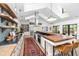 Open kitchen with a large island, wood countertops, bar stools, stainless appliances and an area rug at 3060 Bohicket Rd, Johns Island, SC 29455