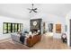 Bright living room featuring modern fireplace, light wood floors, and seamless transition to outdoor views at 3060 Bohicket Rd, Johns Island, SC 29455
