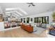 Bright living room featuring light wood floors, vaulted ceilings, and seamless transition to kitchen and dining areas at 3060 Bohicket Rd, Johns Island, SC 29455