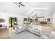Bright living room featuring light wood floors, vaulted ceilings, and seamless transition to kitchen and dining areas at 3060 Bohicket Rd, Johns Island, SC 29455