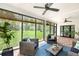 Bright and airy screened-in porch with comfortable seating and scenic backyard views at 3060 Bohicket Rd, Johns Island, SC 29455
