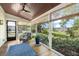 Relaxing screened-in porch boasts abundant natural light and views of landscaped backyard at 3060 Bohicket Rd, Johns Island, SC 29455