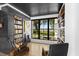 Well-appointed study with custom shelving, a modern fireplace, and a picturesque view at 3060 Bohicket Rd, Johns Island, SC 29455