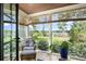 Cozy sun room featuring an armchair, bamboo shades and views of the green backyard at 3060 Bohicket Rd, Johns Island, SC 29455