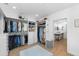 Walk-in closet with custom storage and organization with view into modern white bathroom at 3060 Bohicket Rd, Johns Island, SC 29455