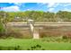 Picturesque view of a charming property featuring a wooden walkway leading to a gazebo overlooking tranquil waters at 3060 Bohicket Rd, Johns Island, SC 29455