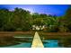 Scenic view of a home on the water, accessible by a wooden pier at 3060 Bohicket Rd, Johns Island, SC 29455
