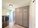 Tiled laundry room featuring modern appliances and storage cabinets at 307 Fairington Dr, Summerville, SC 29485
