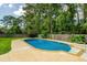Inviting backyard pool with a stone deck and surrounding lush greenery provides a private retreat at 307 Fairington Dr, Summerville, SC 29485