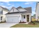 Charming home showcasing a one-car garage, neat landscaping, and attractive architectural details at 316 Abercom Place Dr, Moncks Corner, SC 29461