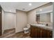 Bathroom featuring a wooden vanity, marble countertop, and a toilet, plus an adjacent walk-in closet at 320 Bedford Rd, Cross, SC 29436
