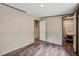 Bedroom with wood-look floors, neutral walls, and view to a walk-in closet and another room at 320 Bedford Rd, Cross, SC 29436