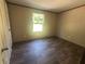 A bedroom with wood-look flooring and a window for natural light at 320 Bedford Rd, Cross, SC 29436