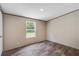 Bedroom featuring a window for natural light, neutral colored walls, and wood-look floors at 320 Bedford Rd, Cross, SC 29436