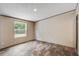 A bright, empty bedroom with light-colored walls, wood-look flooring and a window with outdoor views at 320 Bedford Rd, Cross, SC 29436