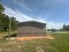 Side of home featuring neutral siding, green grass, and street access at 320 Bedford Rd, Cross, SC 29436