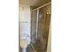 Modern bathroom featuring a toilet, glass enclosed shower, and neutral stone-look tile surround at 330 Concord St # 4B, Charleston, SC 29401