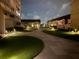 Beautifully landscaped courtyard with lush greenery and walking paths lit by garden lights at 330 Concord St # 4B, Charleston, SC 29401