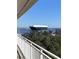 View of a cargo ship from a balcony with white railings and green trees in the foreground at 330 Concord St # 4B, Charleston, SC 29401