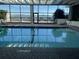 Indoor pool with floor-to-ceiling windows offering marina views and deck chairs for relaxation at 330 Concord St # 4B, Charleston, SC 29401