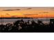 Scenic waterfront sunset view showing dramatic sky colors, calm waters, and distant city lights, creating a serene and picturesque scene at 330 Concord St # 4B, Charleston, SC 29401