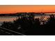 Waterfront view at dusk, with distant buildings and boat traffic enhancing the community's appeal at 330 Concord St # 4B, Charleston, SC 29401