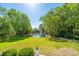 Lovely backyard view with a serene pond, lush trees, and well-maintained lawn at 3502 Stockton Dr, Mount Pleasant, SC 29466