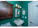 Inviting bathroom with a green wall paint, single sink, and a mirror at 3502 Stockton Dr, Mount Pleasant, SC 29466