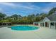 Inviting community pool with lounge chairs and a building, set against a backdrop of trees at 3502 Stockton Dr, Mount Pleasant, SC 29466