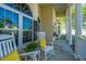 Close-up of a cozy front porch with white rocking chairs and elegant columns, perfect for relaxing at 3502 Stockton Dr, Mount Pleasant, SC 29466