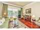 Cozy living room with hardwood floors, large windows, comfortable seating, and access to a screened porch at 3502 Stockton Dr, Mount Pleasant, SC 29466