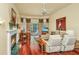 Cozy living room features fireplace, wood floors, and access to screened porch at 3502 Stockton Dr, Mount Pleasant, SC 29466