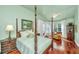 Elegant main bedroom with four poster bed, ceiling fan, and large windows overlooking water at 3502 Stockton Dr, Mount Pleasant, SC 29466