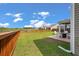 Expansive backyard with a stained wood fence, patio with outdoor seating, and view of a pond at 364 Deep River Rd, Summerville, SC 29486
