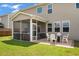 Screened-in back porch with a patio table and set of chairs overlooking the backyard at 364 Deep River Rd, Summerville, SC 29486