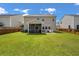 View of the home's backyard with screened in porch and outdoor seating area on a patio at 364 Deep River Rd, Summerville, SC 29486