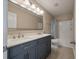 Bathroom featuring double sinks, large mirror, cabinet storage and a shower-tub combo at 364 Deep River Rd, Summerville, SC 29486