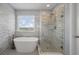 Modern bathroom featuring a soaking tub and glass-enclosed shower with stylish tile at 364 Deep River Rd, Summerville, SC 29486