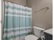 Cozy bathroom featuring a shower with striped curtain and a standard toilet at 364 Deep River Rd, Summerville, SC 29486