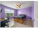 Bedroom with a window and a wooden framed bed next to a desk and office chair at 364 Deep River Rd, Summerville, SC 29486