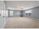 Large bonus room featuring carpet floors, bright windows, ceiling fan, and a rocking horse at 364 Deep River Rd, Summerville, SC 29486