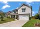 Charming two-story home with a stone front and manicured lawn in a suburban neighborhood at 364 Deep River Rd, Summerville, SC 29486