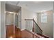 Upstairs hallway featuring wood floors, decorative railing, and neutral color palette at 364 Deep River Rd, Summerville, SC 29486