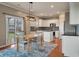 Modern kitchen with a central island, stainless steel appliances, and bright white cabinets at 364 Deep River Rd, Summerville, SC 29486