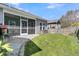The backyard features a screened in porch, stone patio, and a lush green lawn at 3968 Hanoverian Dr, Mount Pleasant, SC 29429